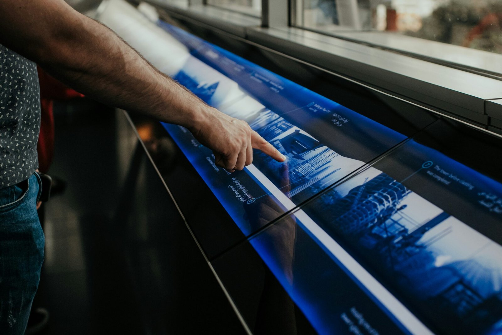 a man is pointing at a large poster